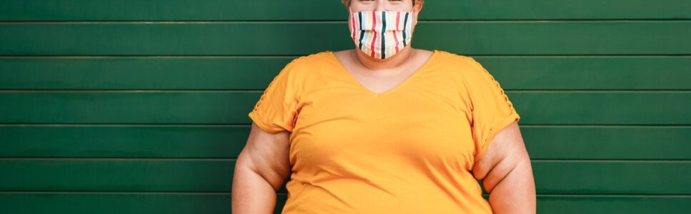 Happy plus size woman wearing a face protective mask during coronavirus outbreak - Focus on face Ayurvedic Treatment For Obesity Sydney